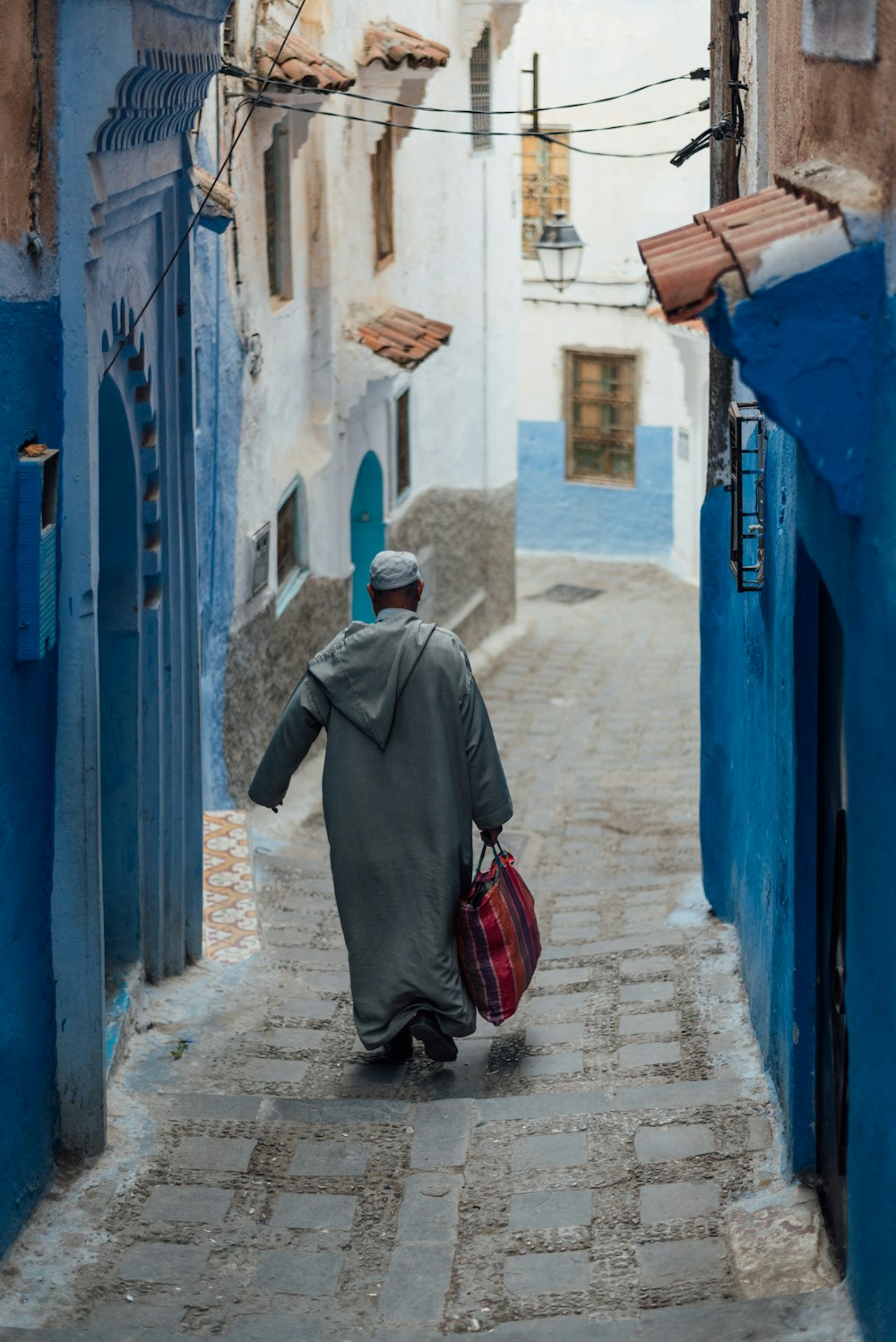 a man walking down a narrow alley way