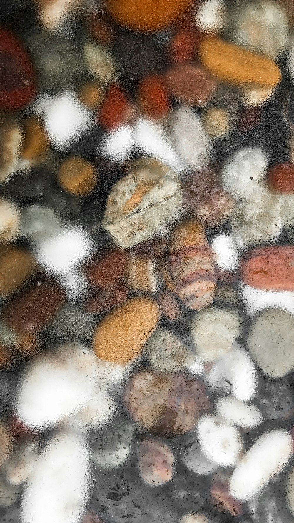 a close up of rocks and pebbles under water