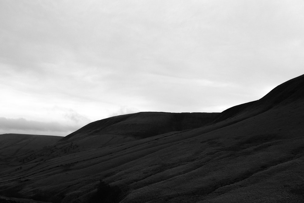 a black and white photo of a hill