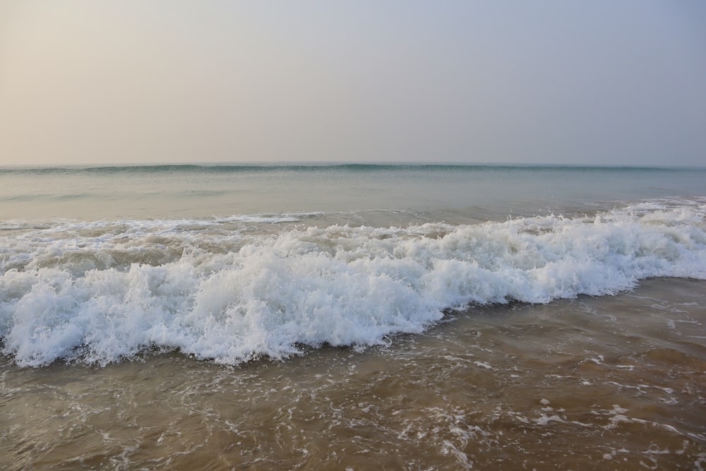 a large body of water with waves coming in to shore