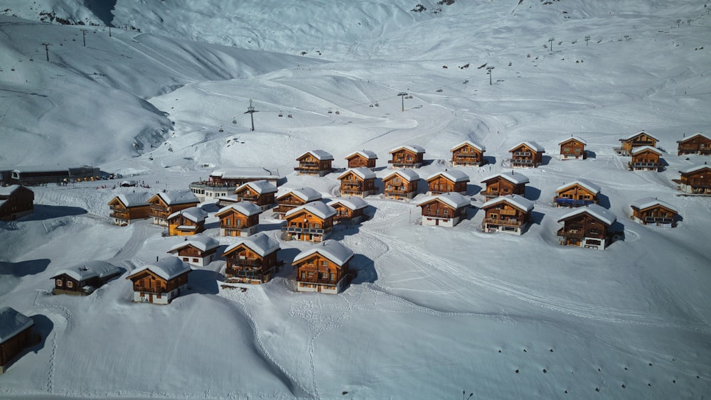 a group of houses in the middle of a snow covered mountain
