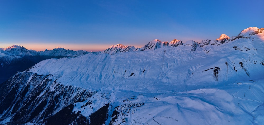 a mountain covered in snow under a blue sky