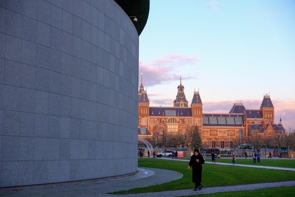 a woman standing in front of a large building