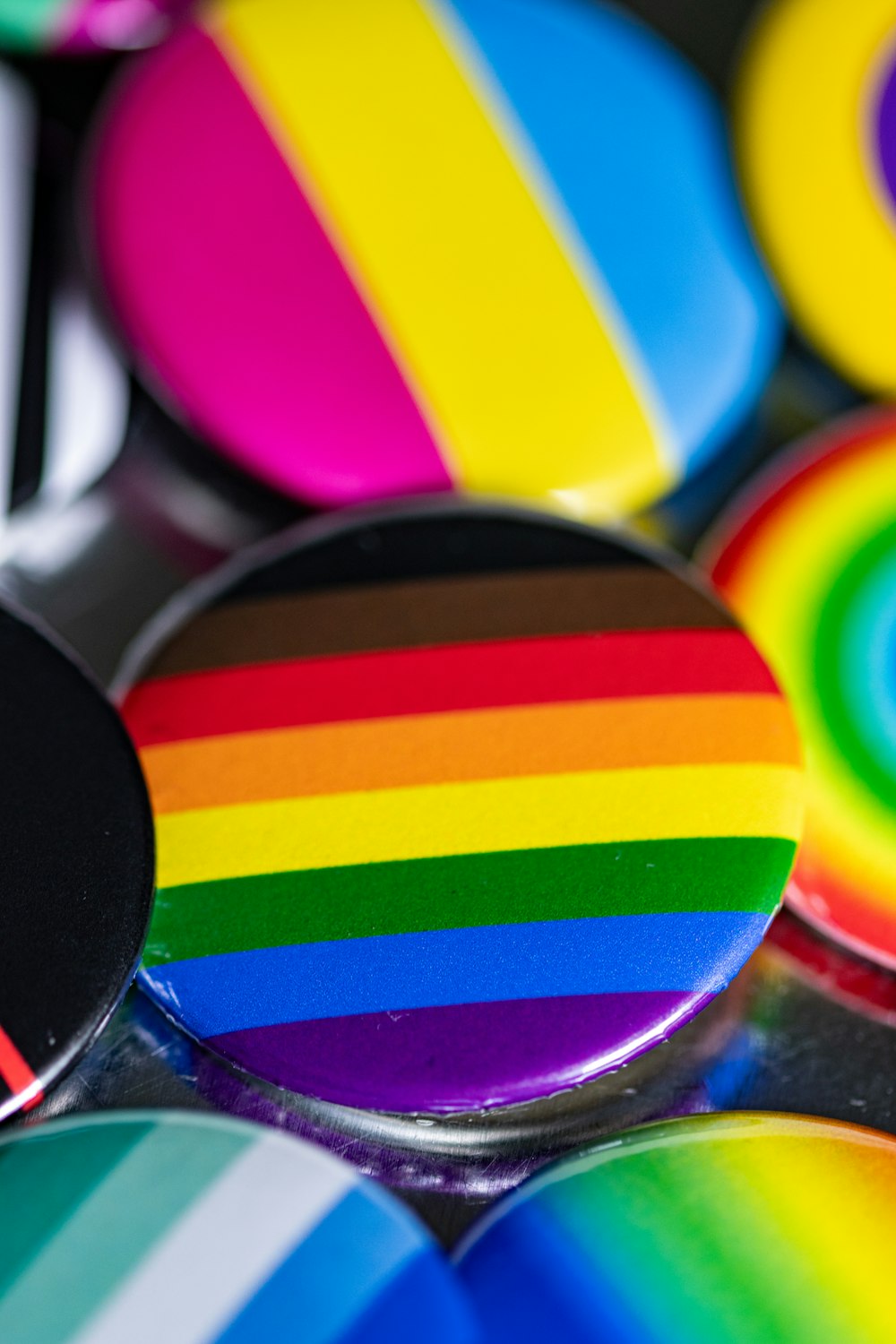 a close up of a rainbow colored button