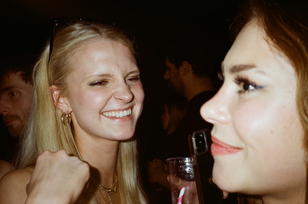 two beautiful young women standing next to each other