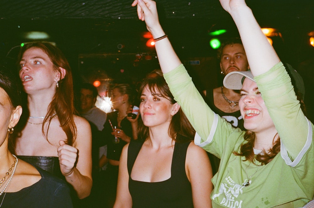 a group of people standing around each other at a party