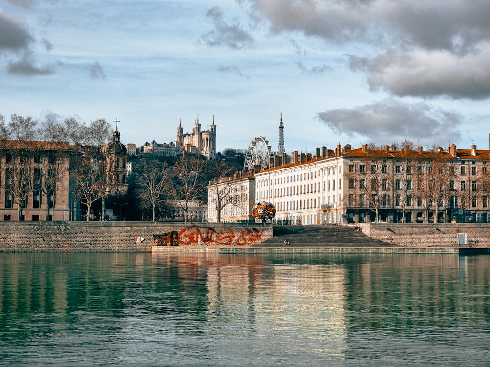 a body of water with buildings in the background