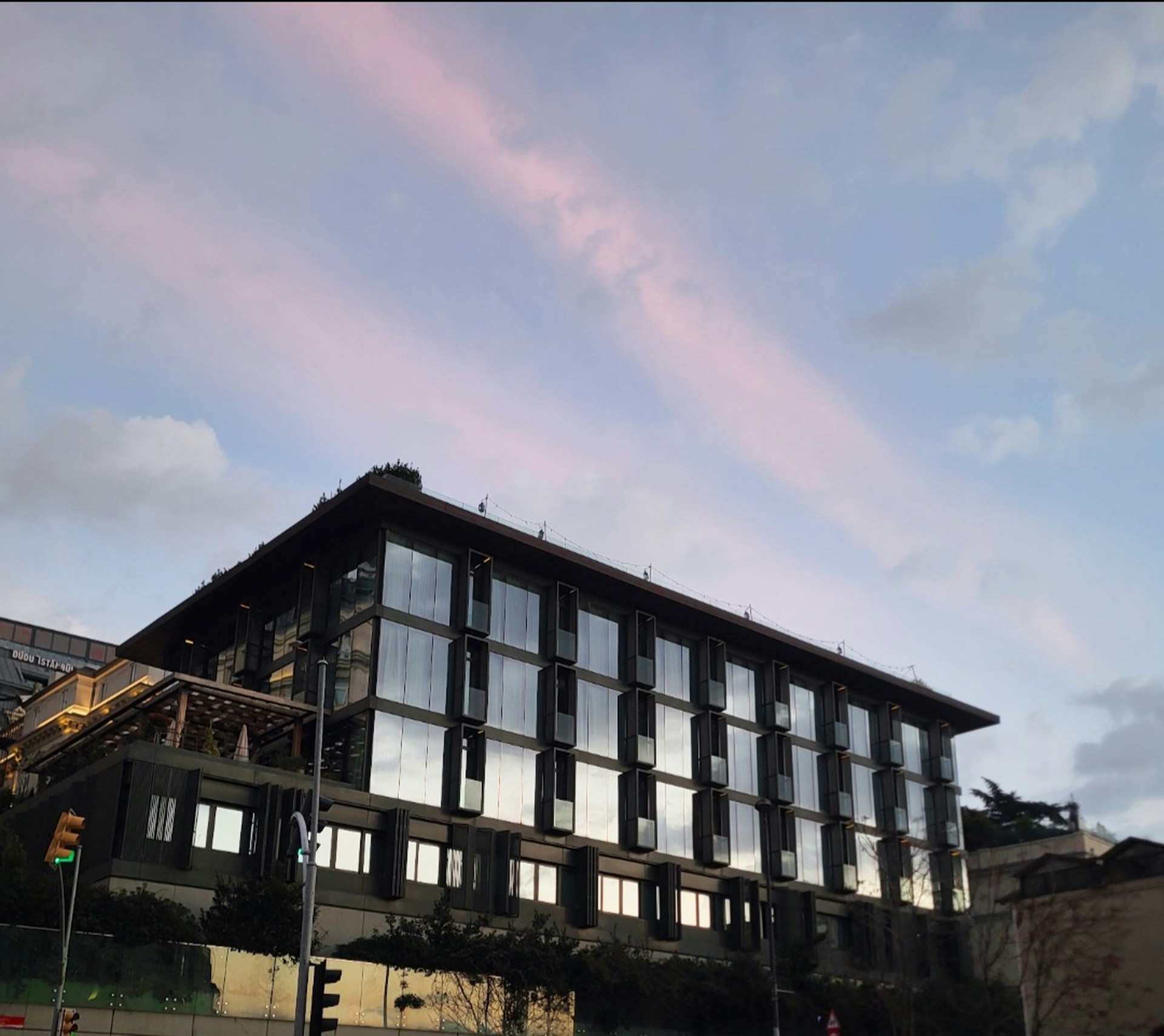 a large building with lots of windows and a sky background