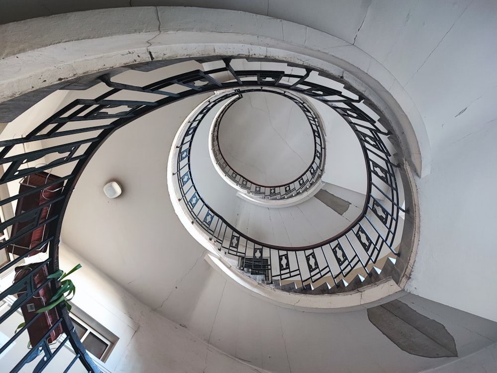 a spiral staircase in a building with metal railings