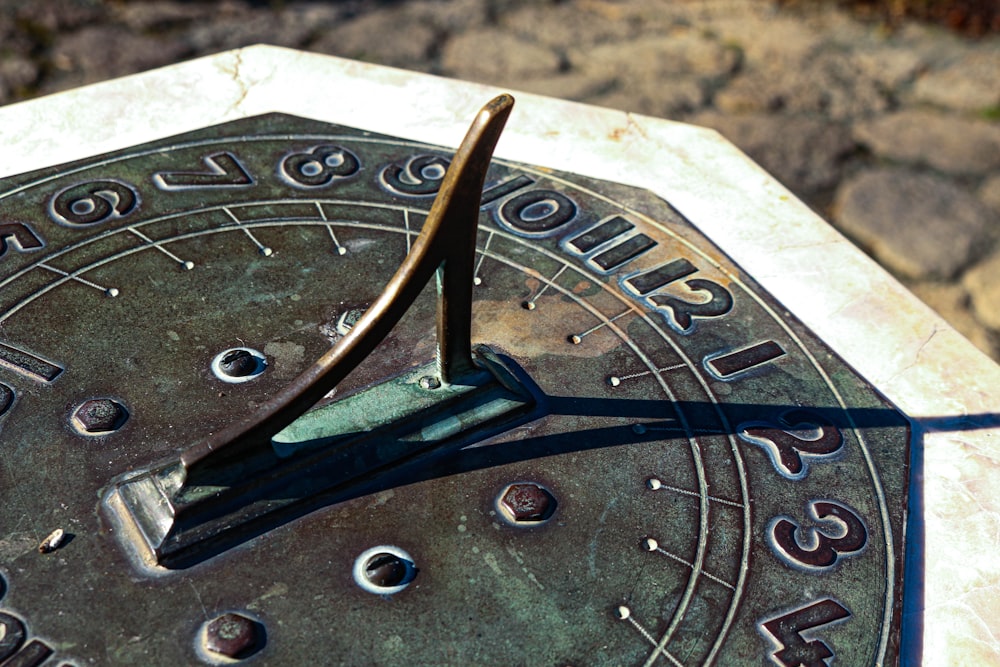 a close up of a metal clock with numbers on it