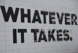 a white brick wall with black words on it