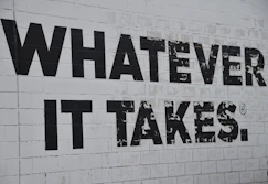 a white brick wall with black words on it