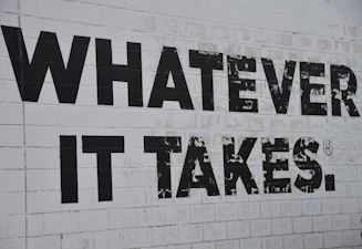 a white brick wall with black words on it