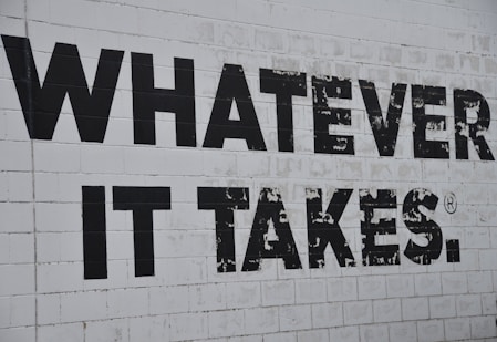 a white brick wall with black words on it