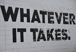 a white brick wall with black words on it