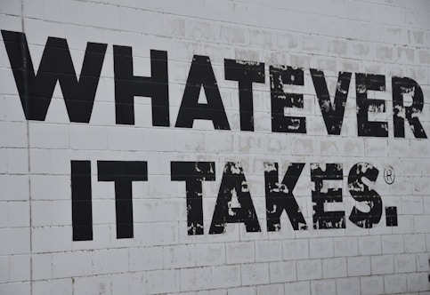 a white brick wall with black words on it