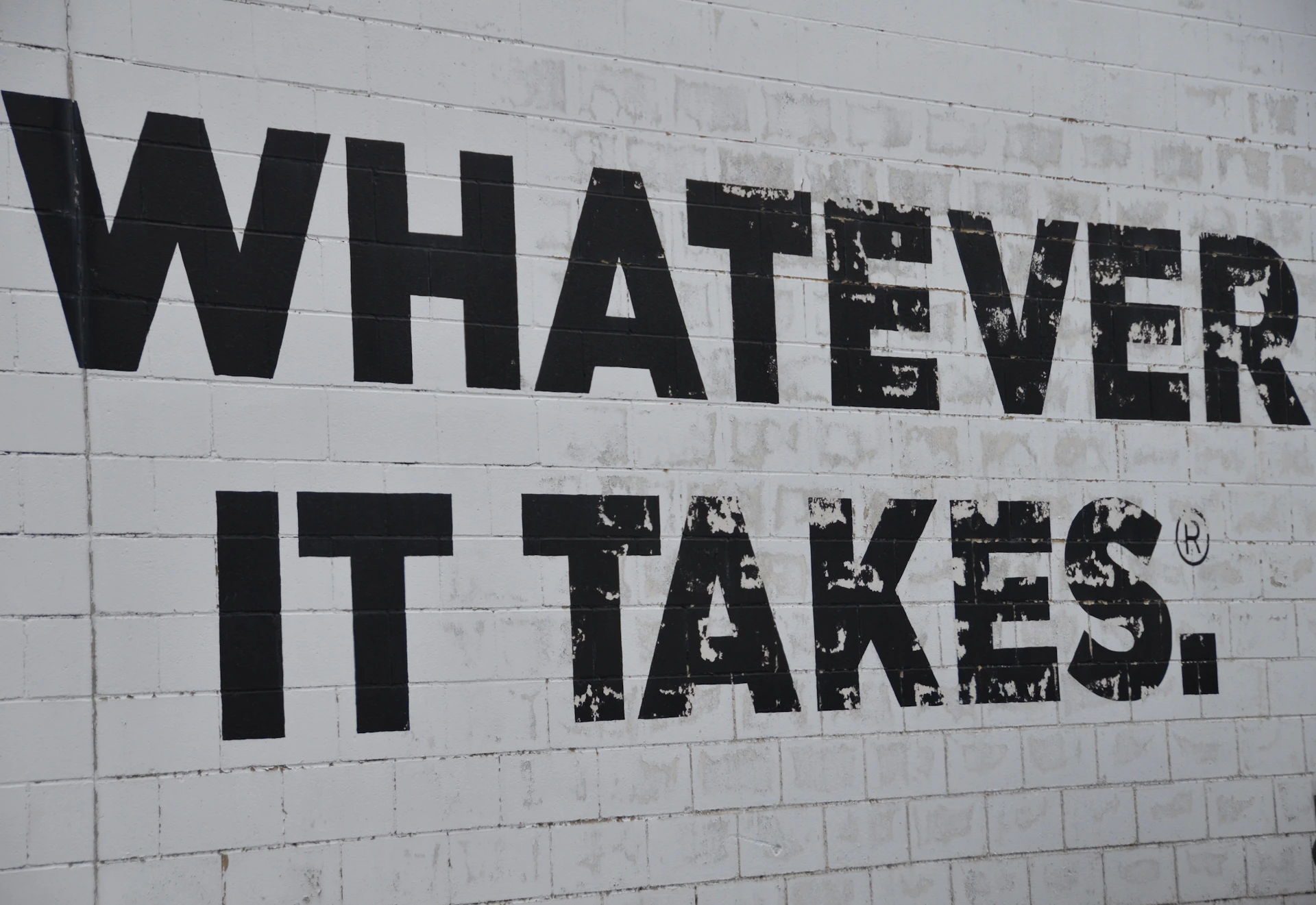 a white brick wall with black words on it