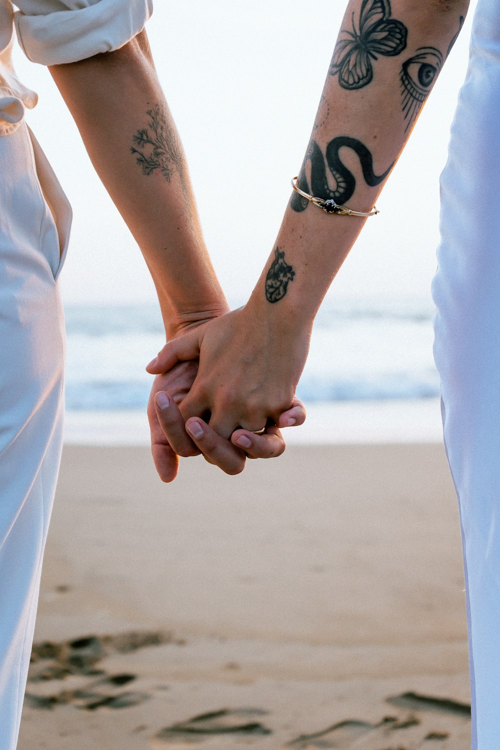 a close up of two people holding hands