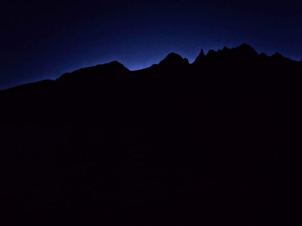 a black and blue photo of a mountain range