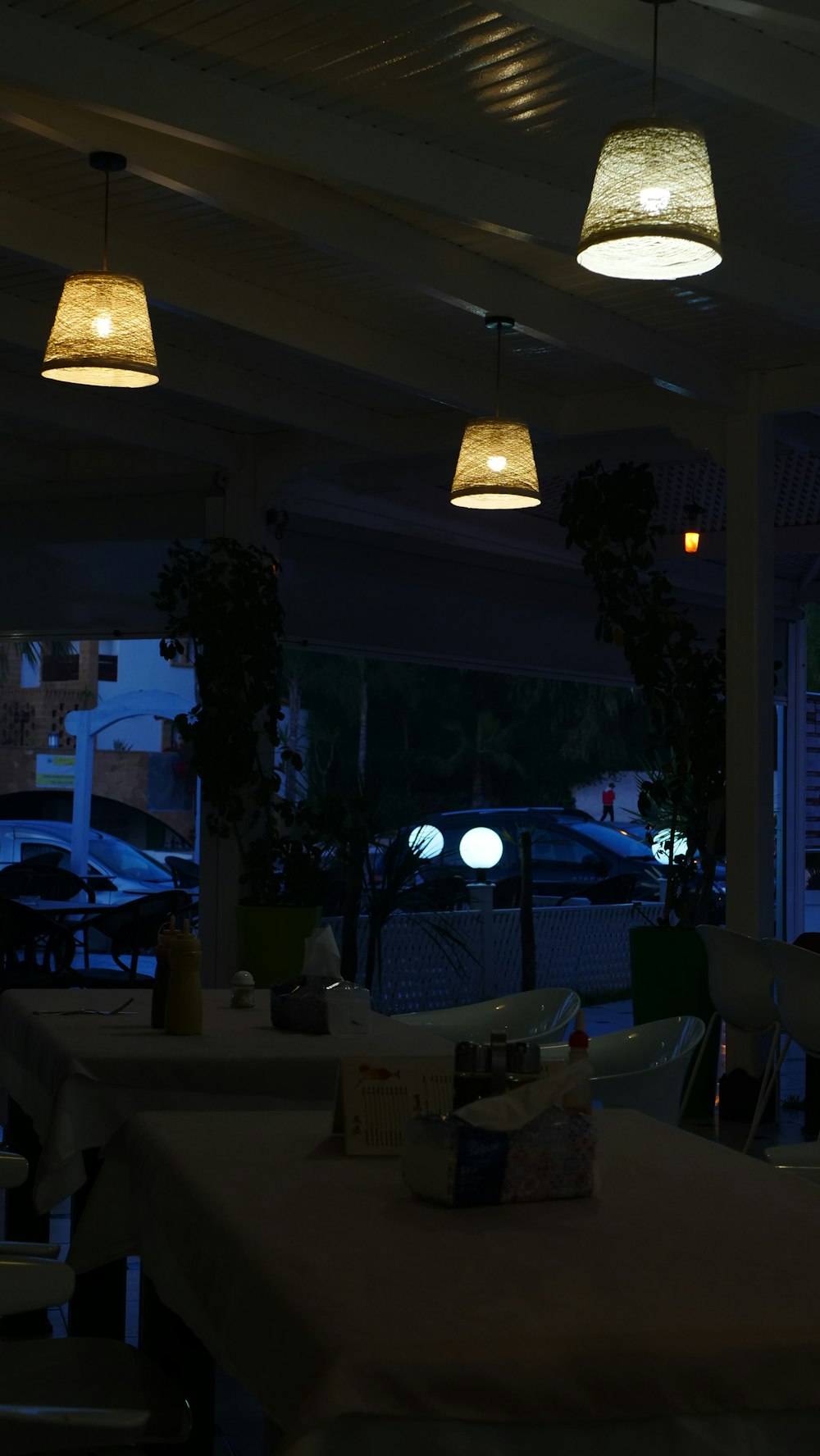 a restaurant with tables and chairs and lights