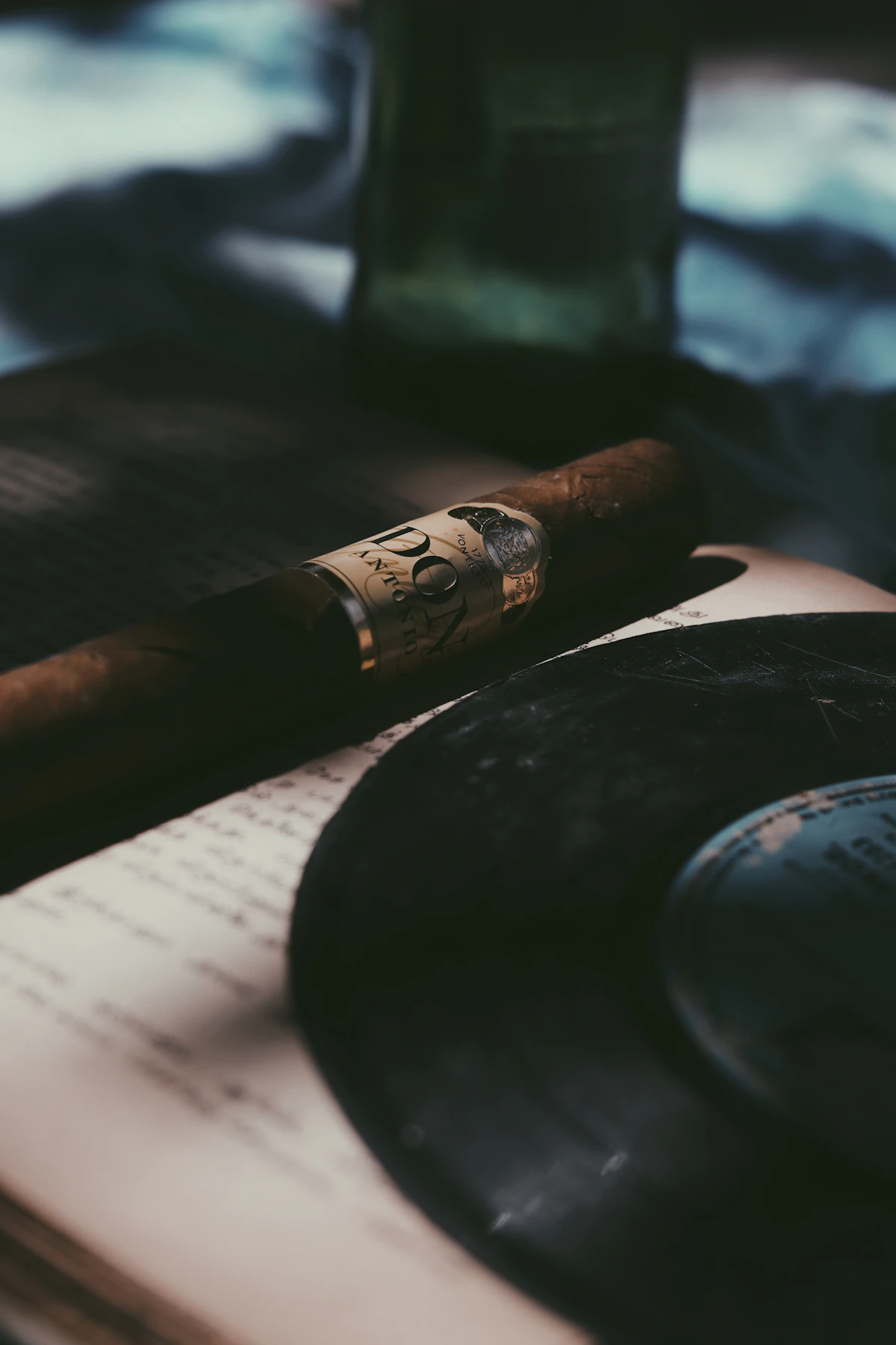 Single elegant cigar resting on a polished dark surface