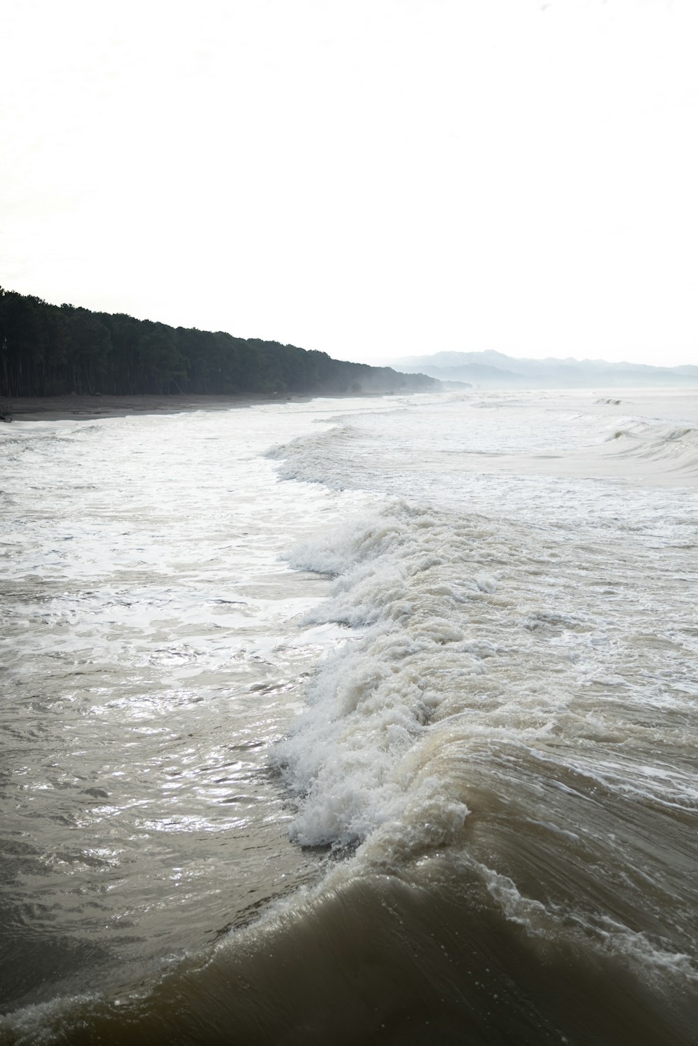 a person riding a surfboard on top of a wave