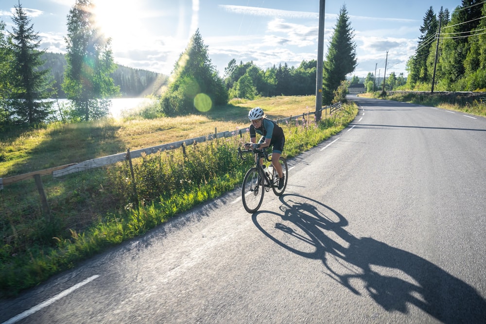 a man riding a bike down a curvy road