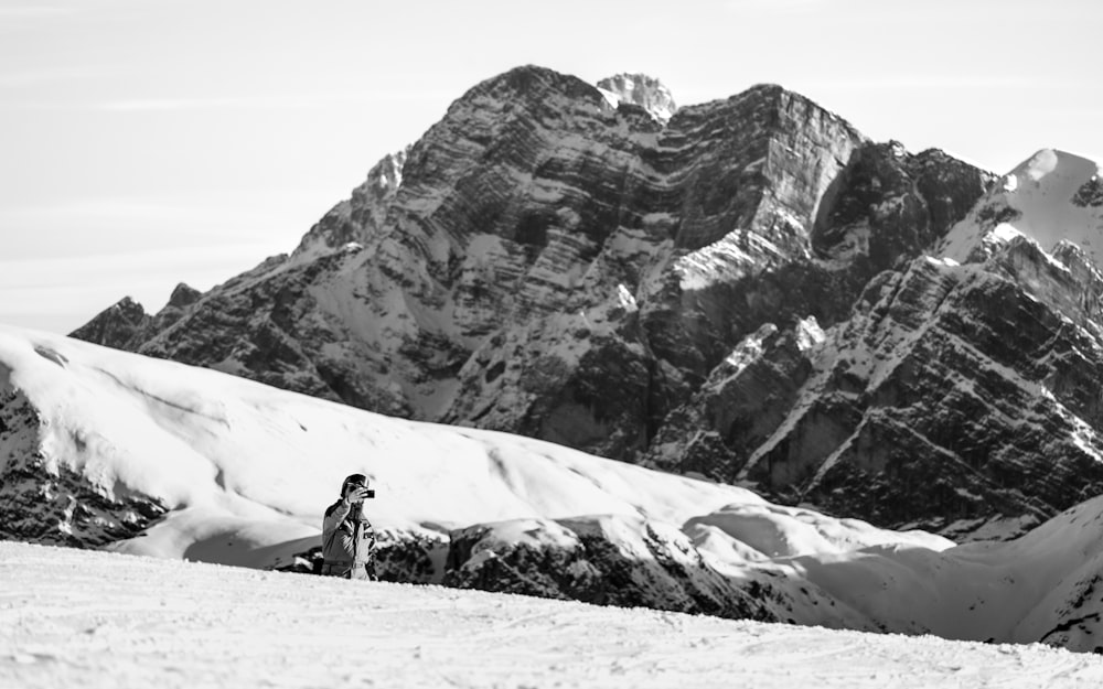 a man riding skis on top of a snow covered slope