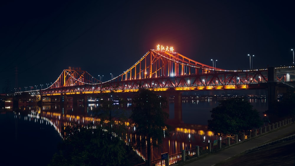 a large long bridge over a river at night
