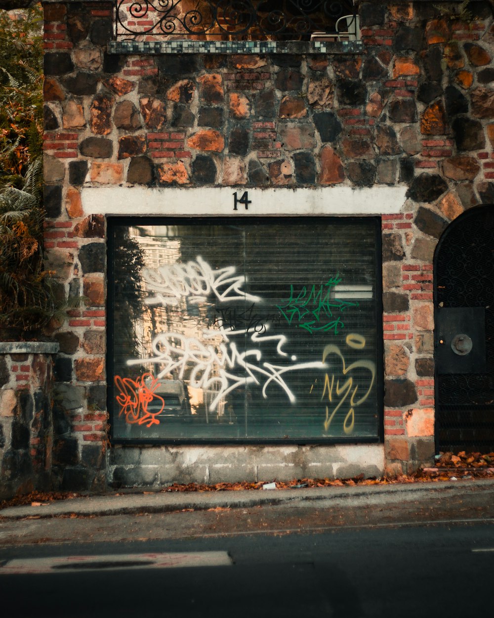 a brick building with graffiti on the side of it