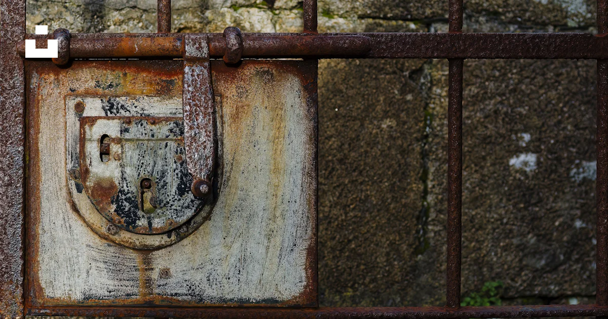 A rusted iron gate with a padlock on it photo – Free Background Image ...