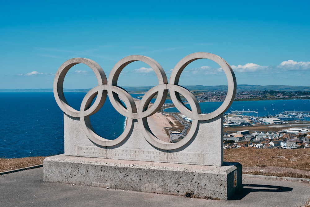 a monument with a large metal olympic symbol on top of it