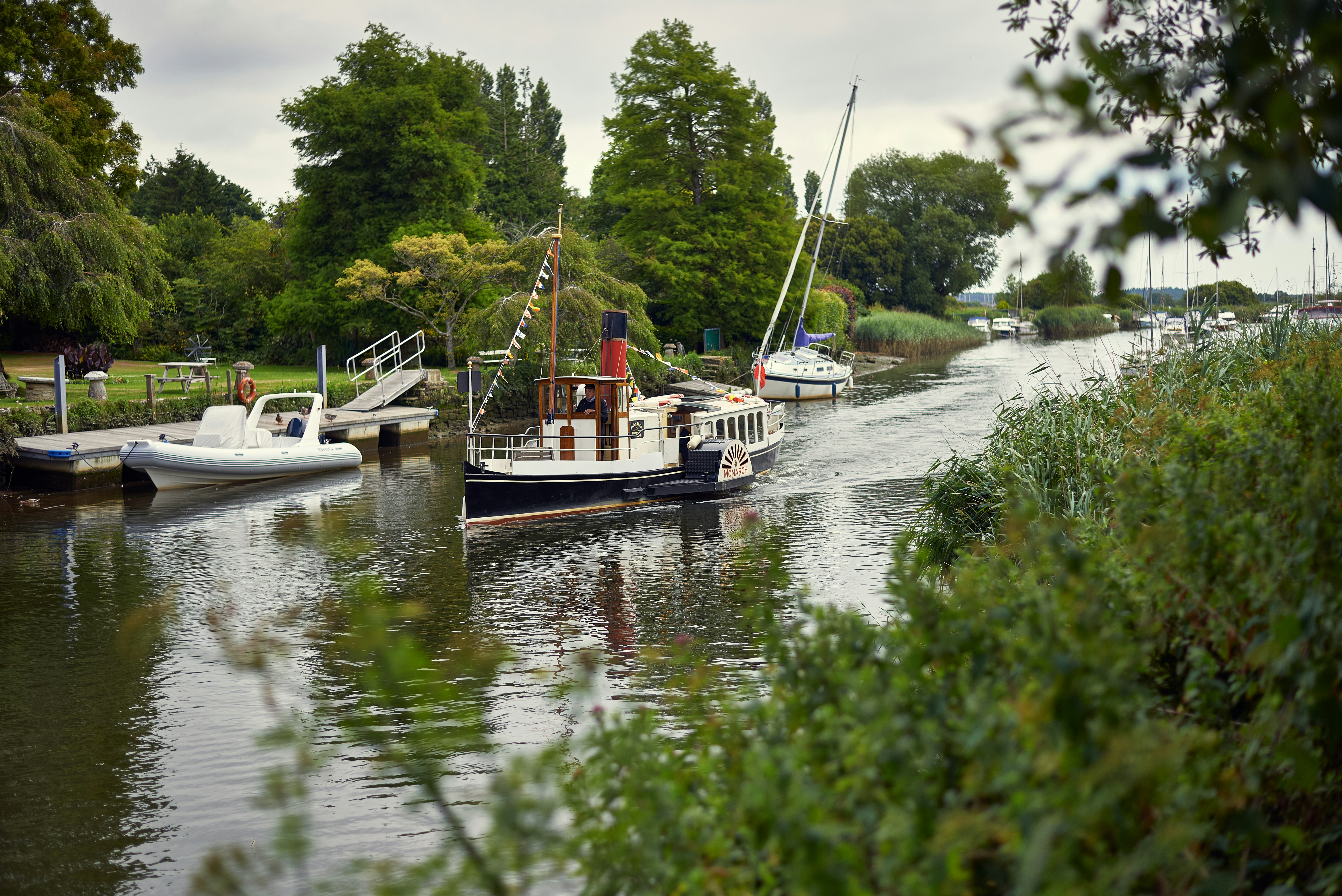 several boats are docked on the water in a park