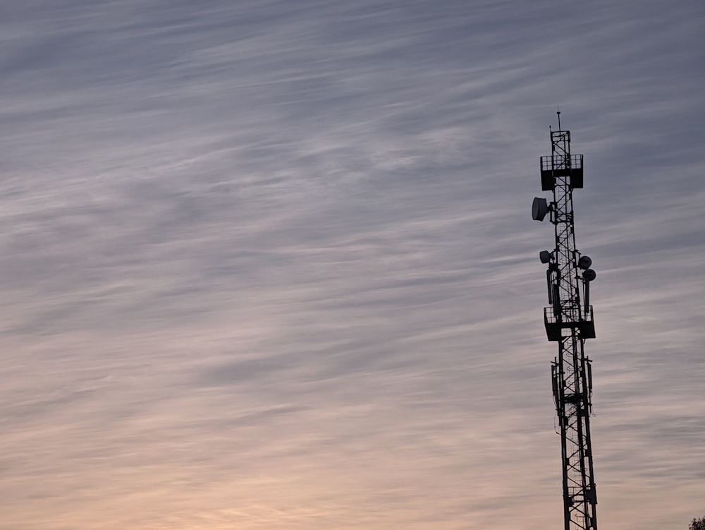 a tall tower with a cell phone on top of it