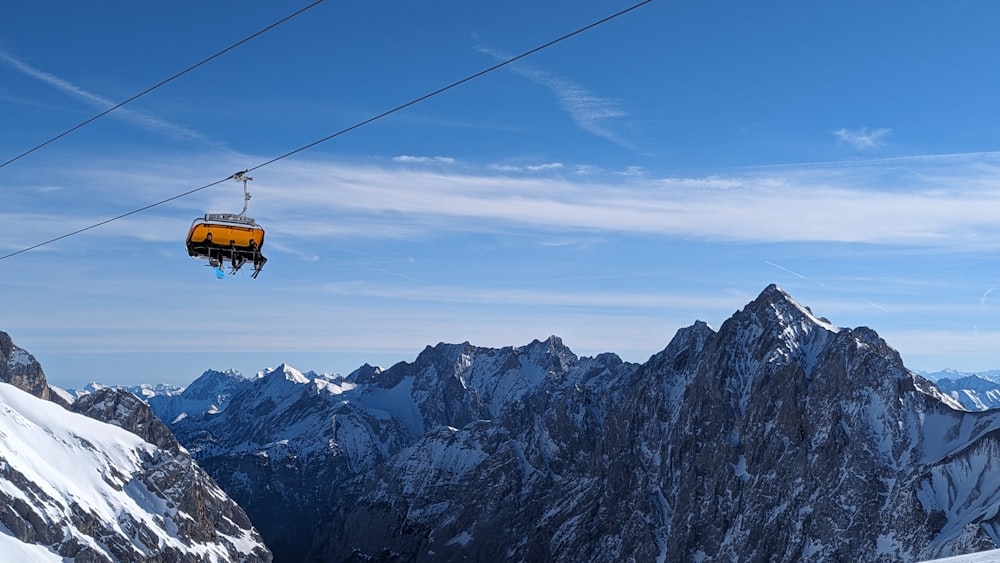 a ski lift going up a snowy mountain