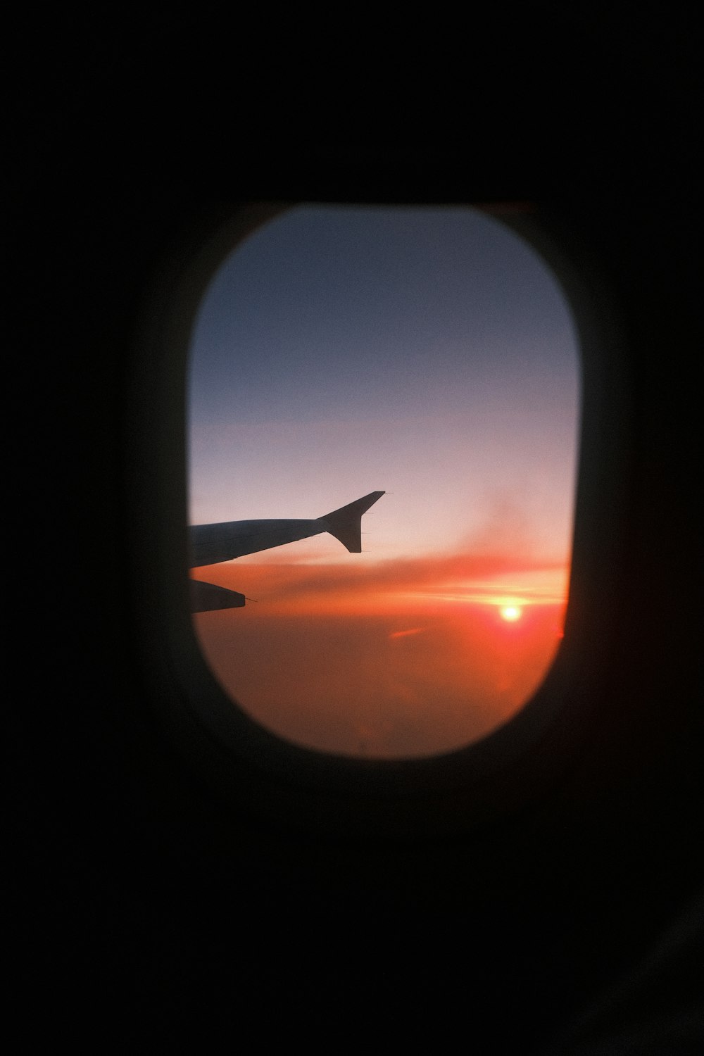 a view of a sunset through an airplane window