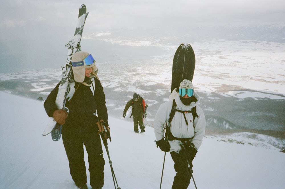 a group of people walking up a snow covered slope