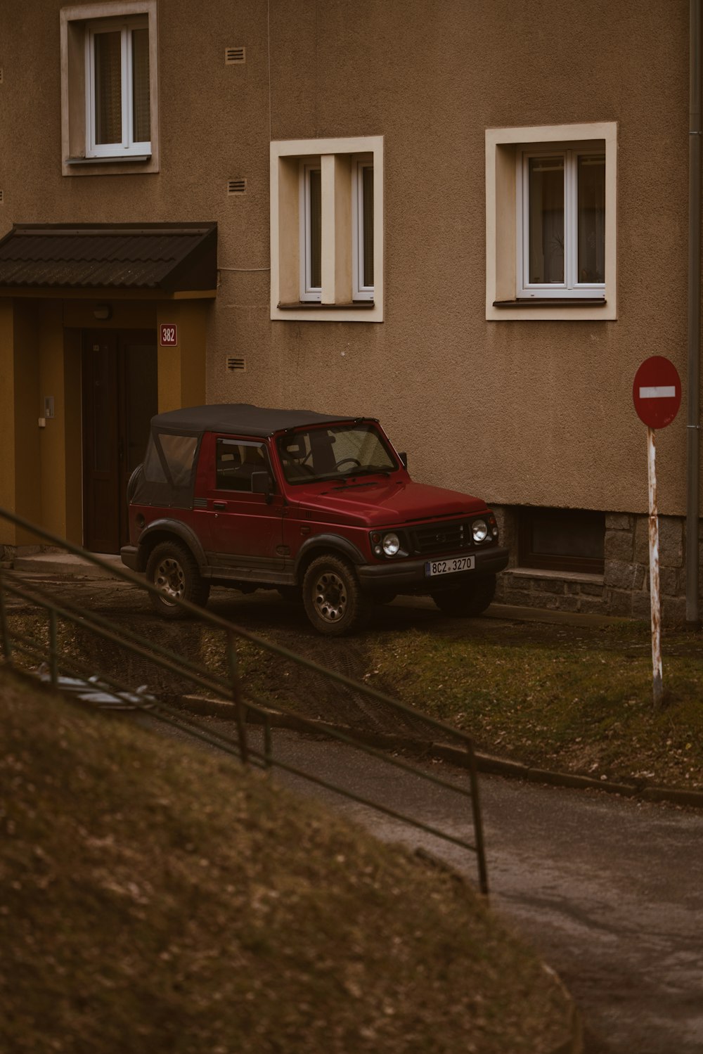 a red car parked in front of a house