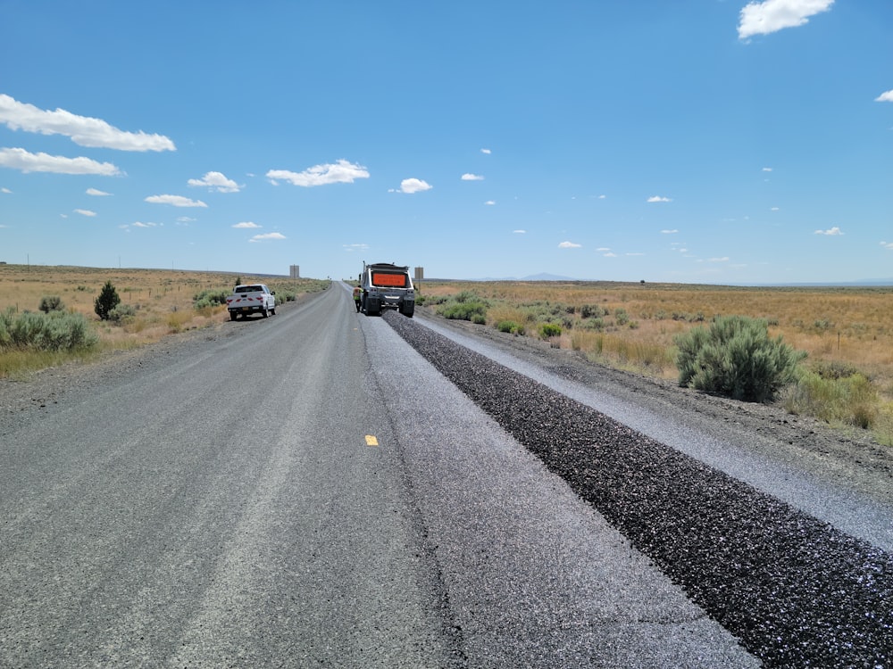 a couple of trucks that are on a road