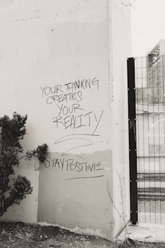 a black and white photo of graffiti on a wall