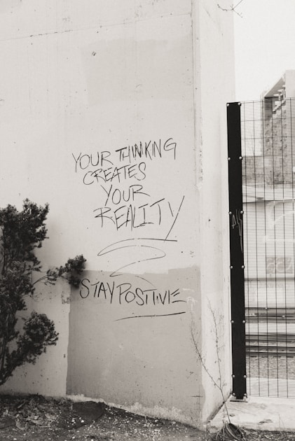 a black and white photo of graffiti on a wall