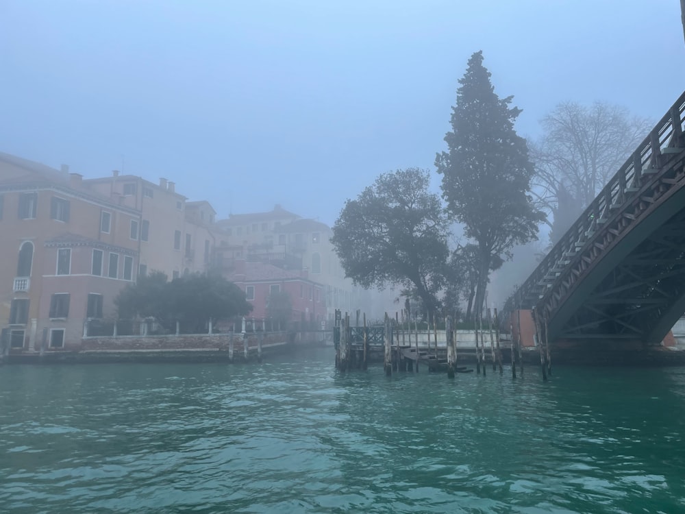 a bridge over a body of water with buildings in the background