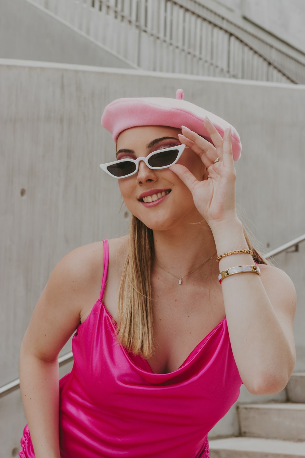 a woman wearing a pink hat and sunglasses