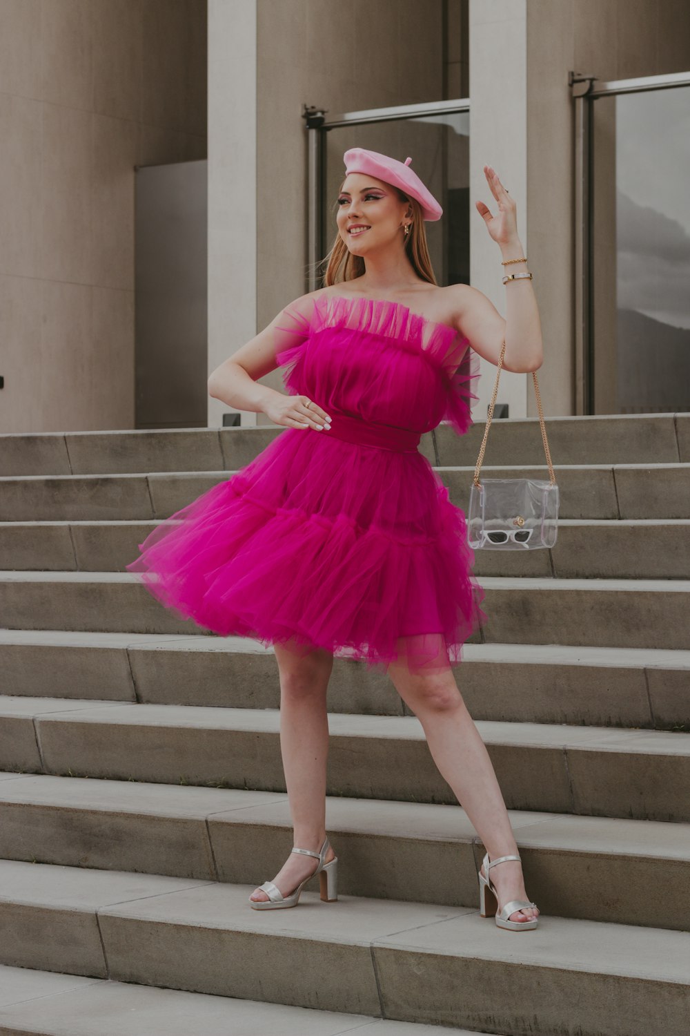 a woman in a pink dress and pink hat