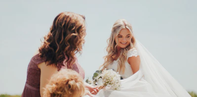 a woman in a wedding dress holding a bouquet of flowers