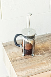 a french press coffee maker on a wooden table