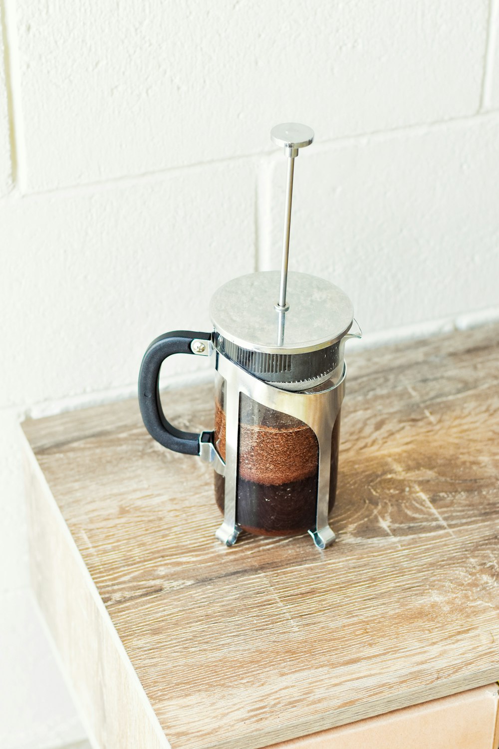 a french press coffee maker on a wooden table