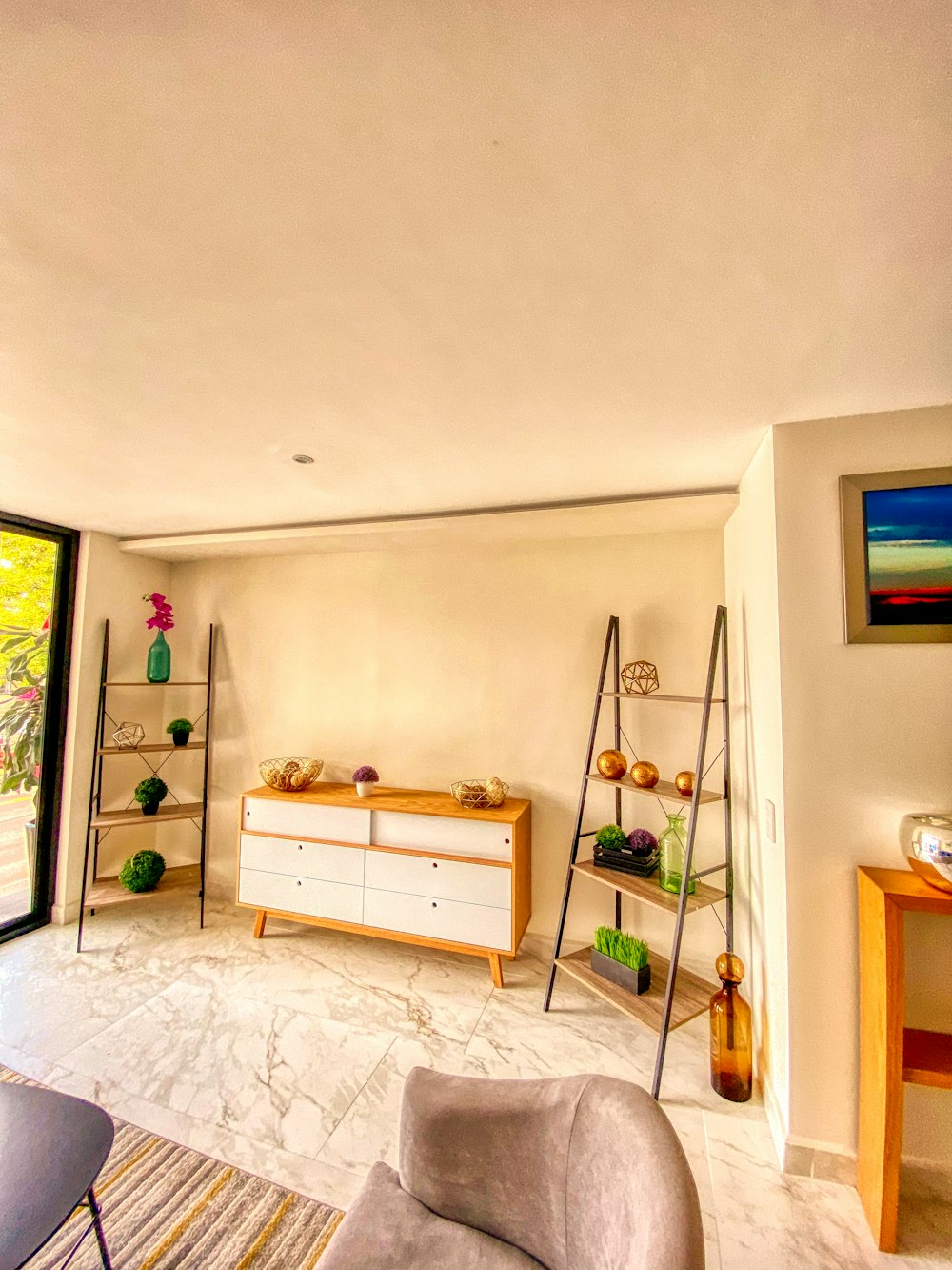 a living room filled with furniture and a large window