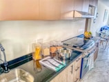 a kitchen with a sink, stove and counter top