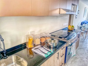 a kitchen with a sink, stove and counter top